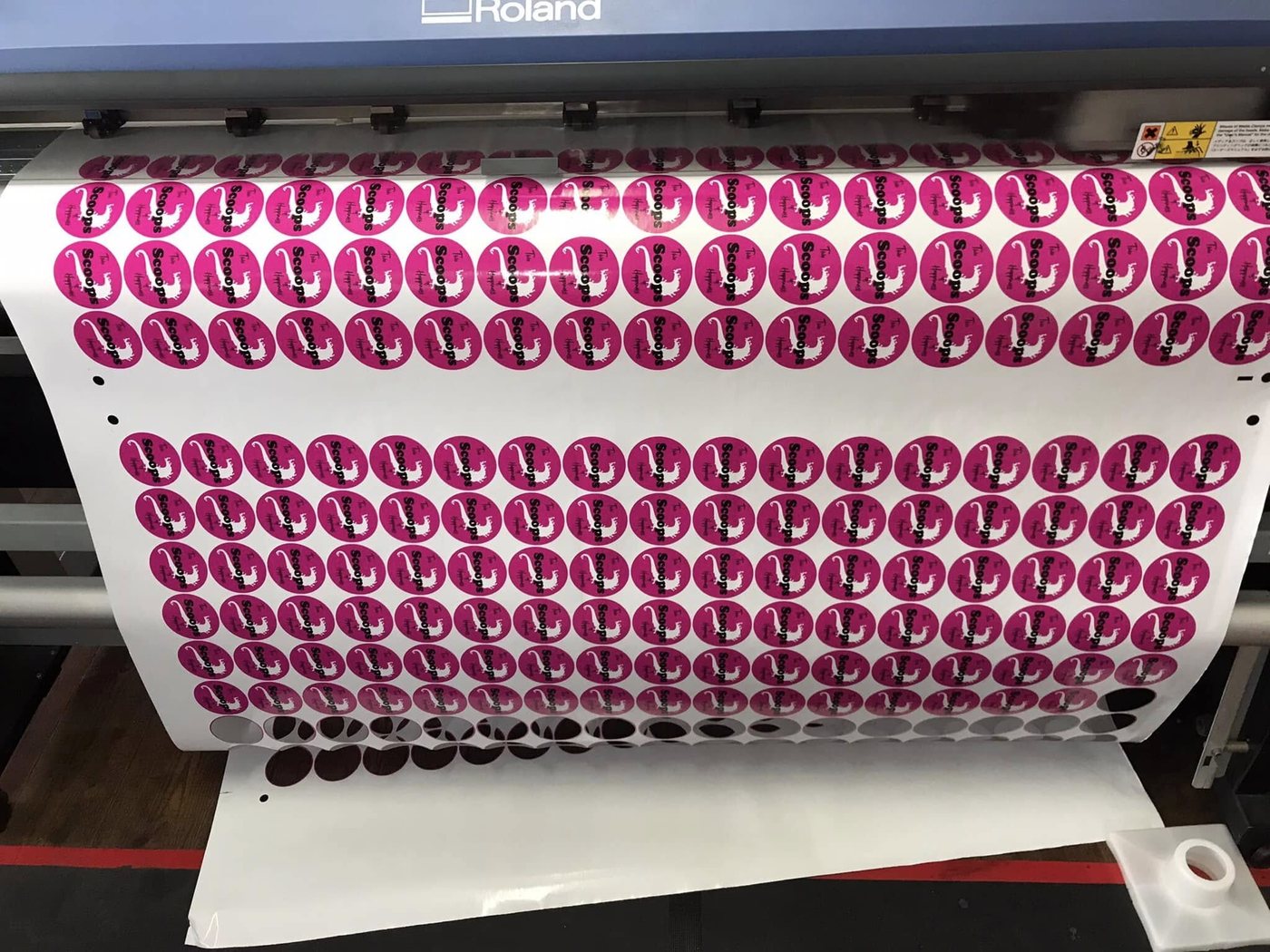 Sticker roll printed with pink round labels